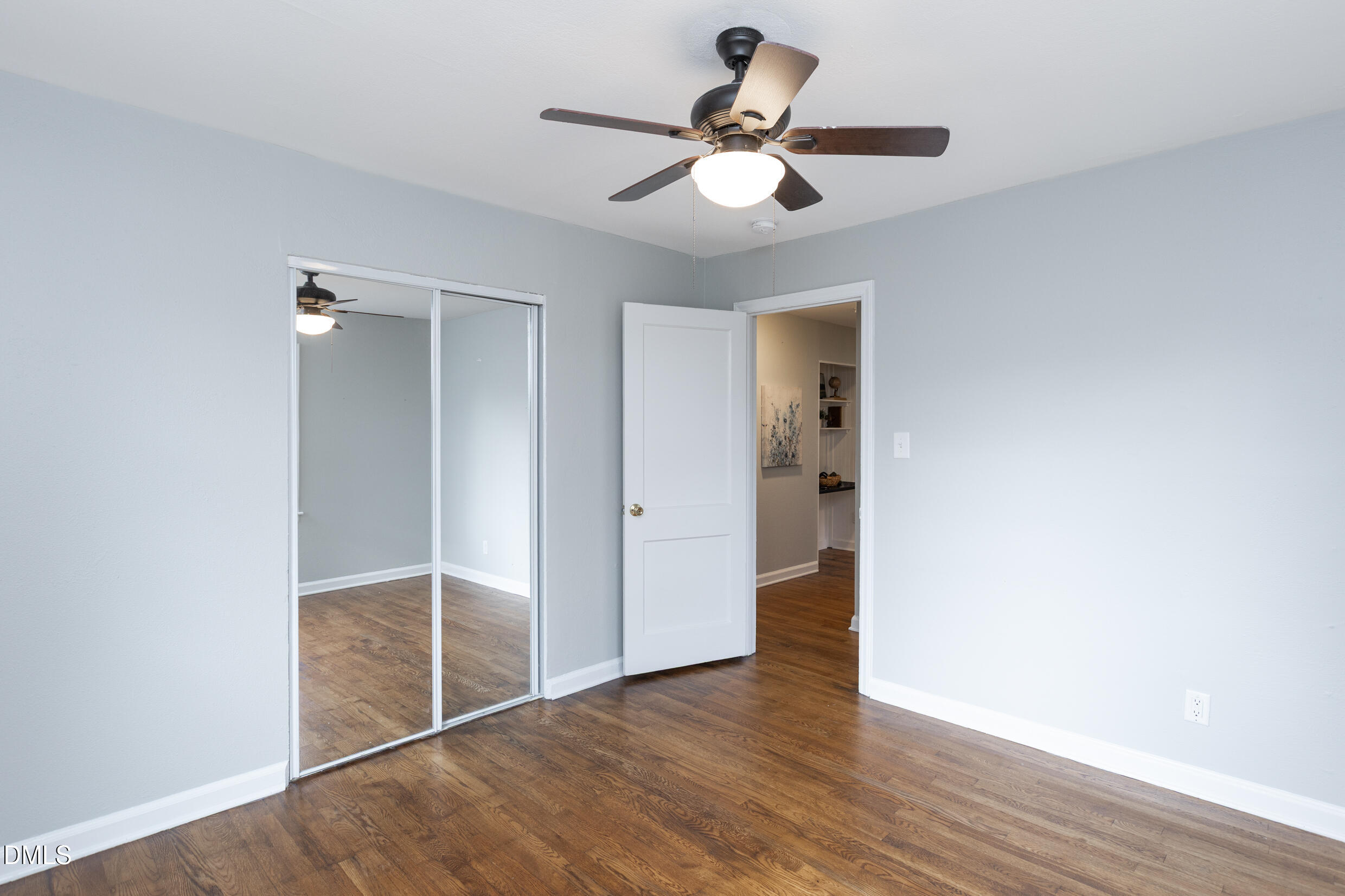 1206 Downing Road Raleigh, NC 27610 - Photo 11 of 13 an empty room to hallway with wooden floor