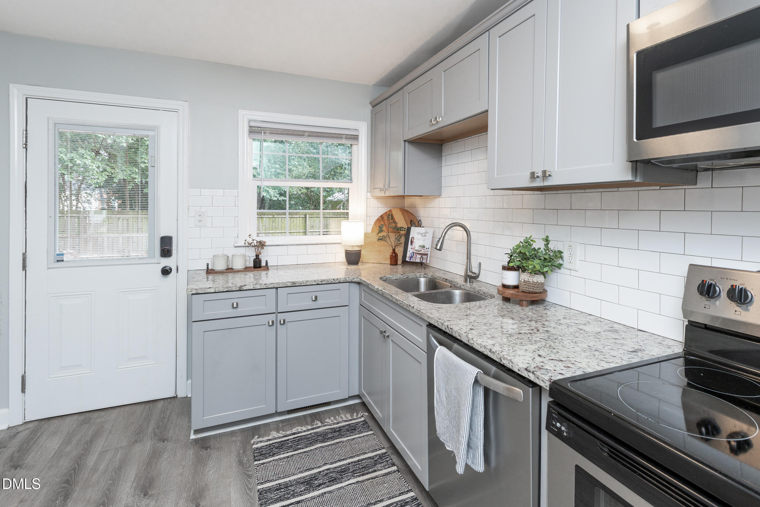 1206 Downing Road Raleigh, NC 27610 - Photo 4 of 13 a kitchen with sink cabinets and window