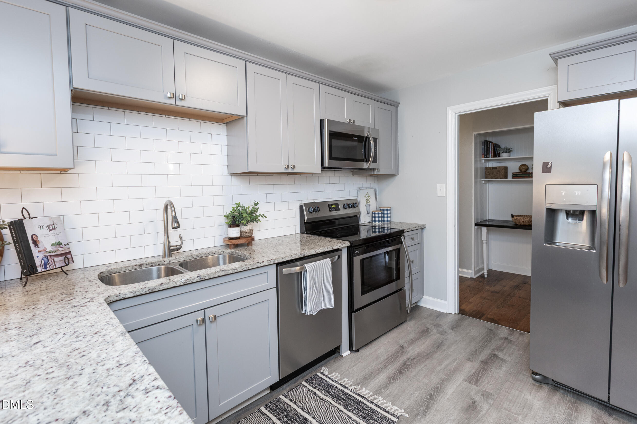 1206 Downing Road Raleigh, NC 27610 - Photo 5 of 13 a kitchen with stainless steel appliances granite countertop a refrigerator sink and stove