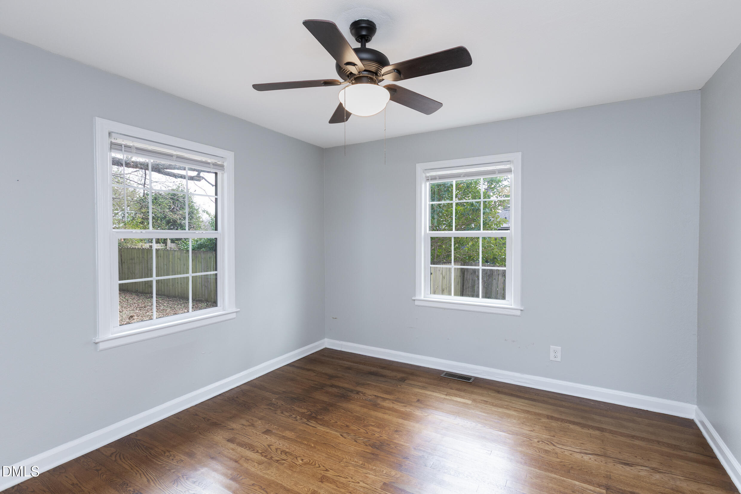 1206 Downing Road Raleigh, NC 27610 - Photo 10 of 13 a view of an empty room with wooden floor and a window