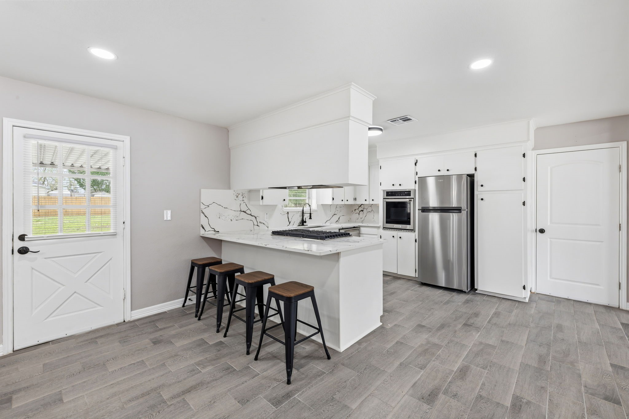 202 Massey Tompkins Road Baytown, TX 77521 - Photo 11 of 47 a kitchen with stainless steel appliances granite countertop a refrigerator and a stove top oven