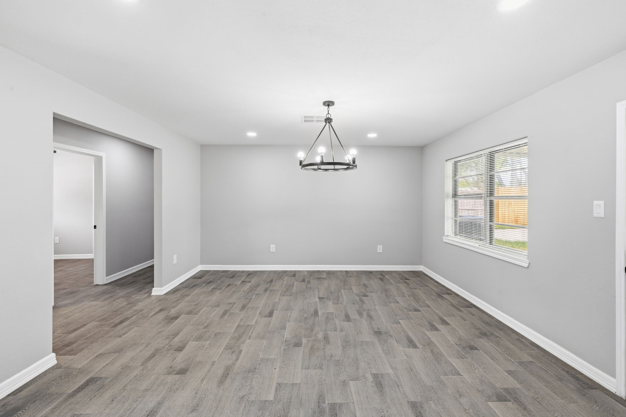 202 Massey Tompkins Road Baytown, TX 77521 - Photo 12 of 47 an empty room with wooden floor cabinet and windows