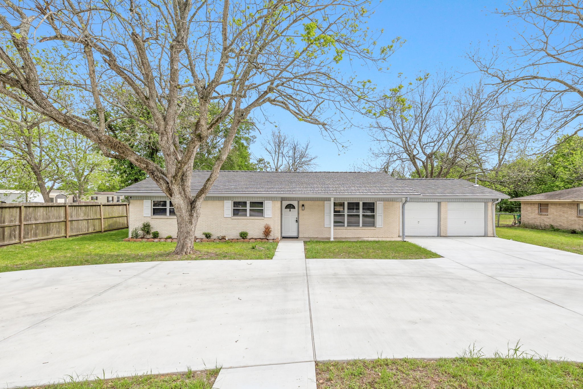 202 Massey Tompkins Road Baytown, TX 77521 - Photo 2 of 47 a house that has a tree in front of it