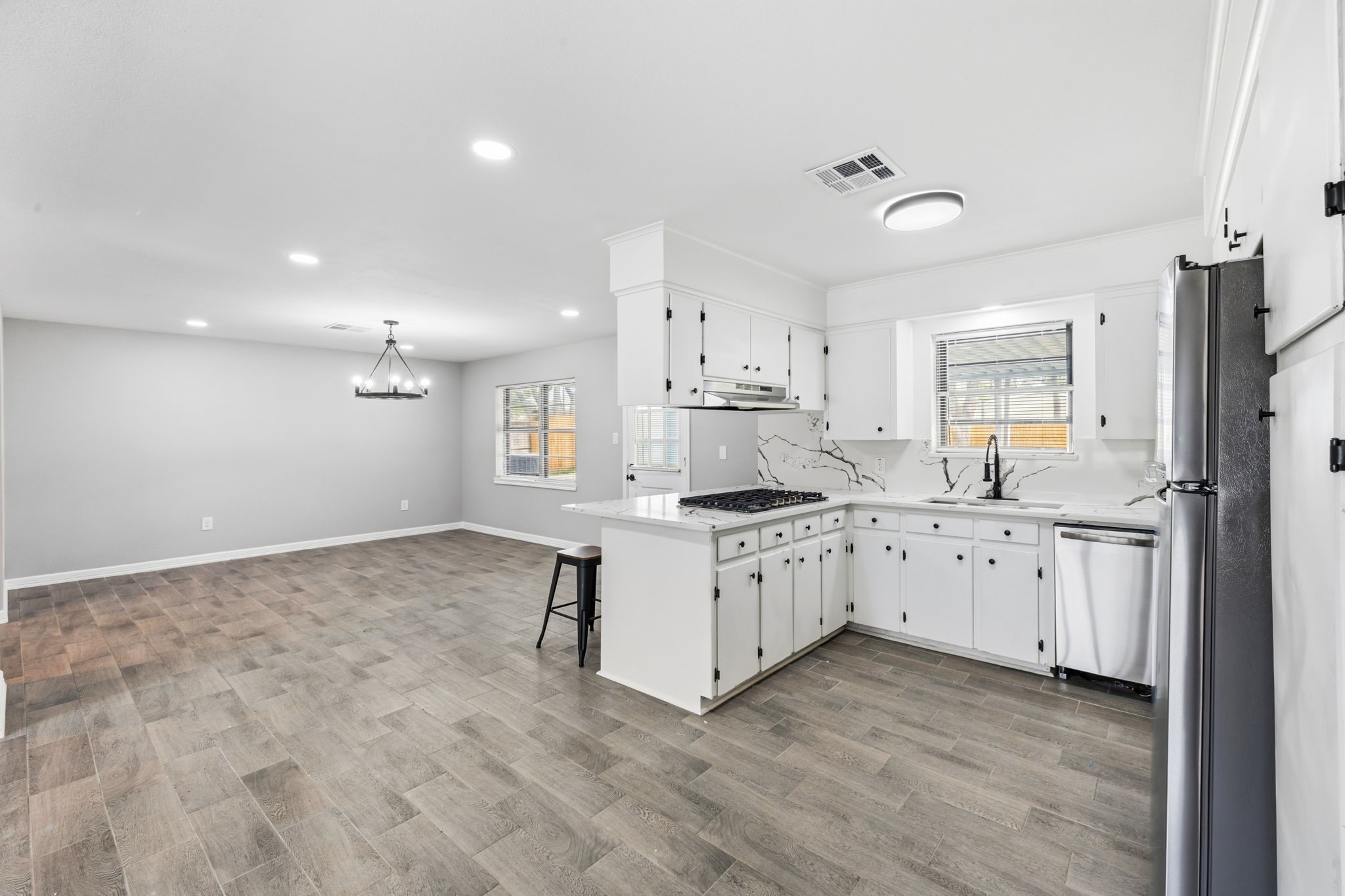 202 Massey Tompkins Road Baytown, TX 77521 - Photo 23 of 47 a large kitchen with granite countertop a stove top oven a sink a window and a refrigerator