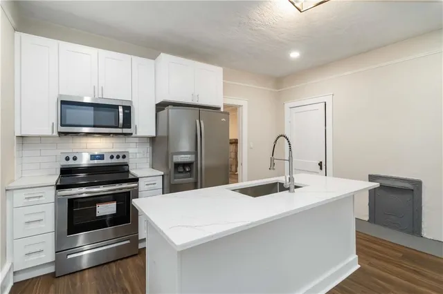 a kitchen with stainless steel appliances a refrigerator stove and microwave