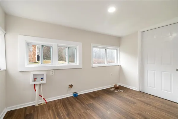 a view of a room with wooden floor and windows