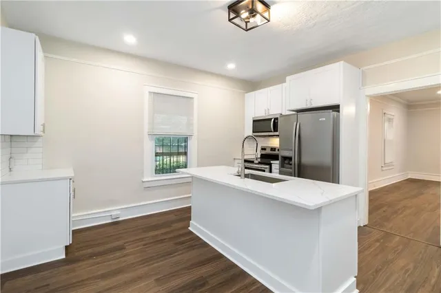 a kitchen with a refrigerator sink and stove