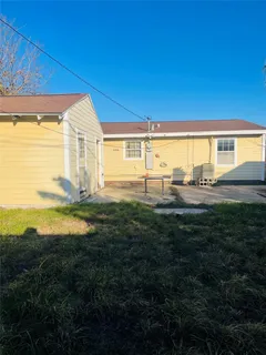 a backyard of a house with table and chairs