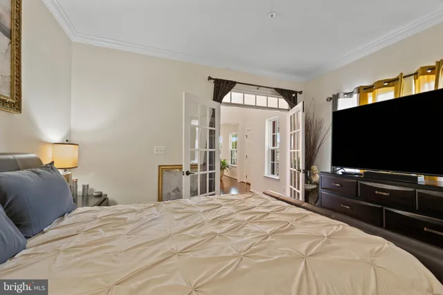 a bedroom with a bed and a flat screen tv