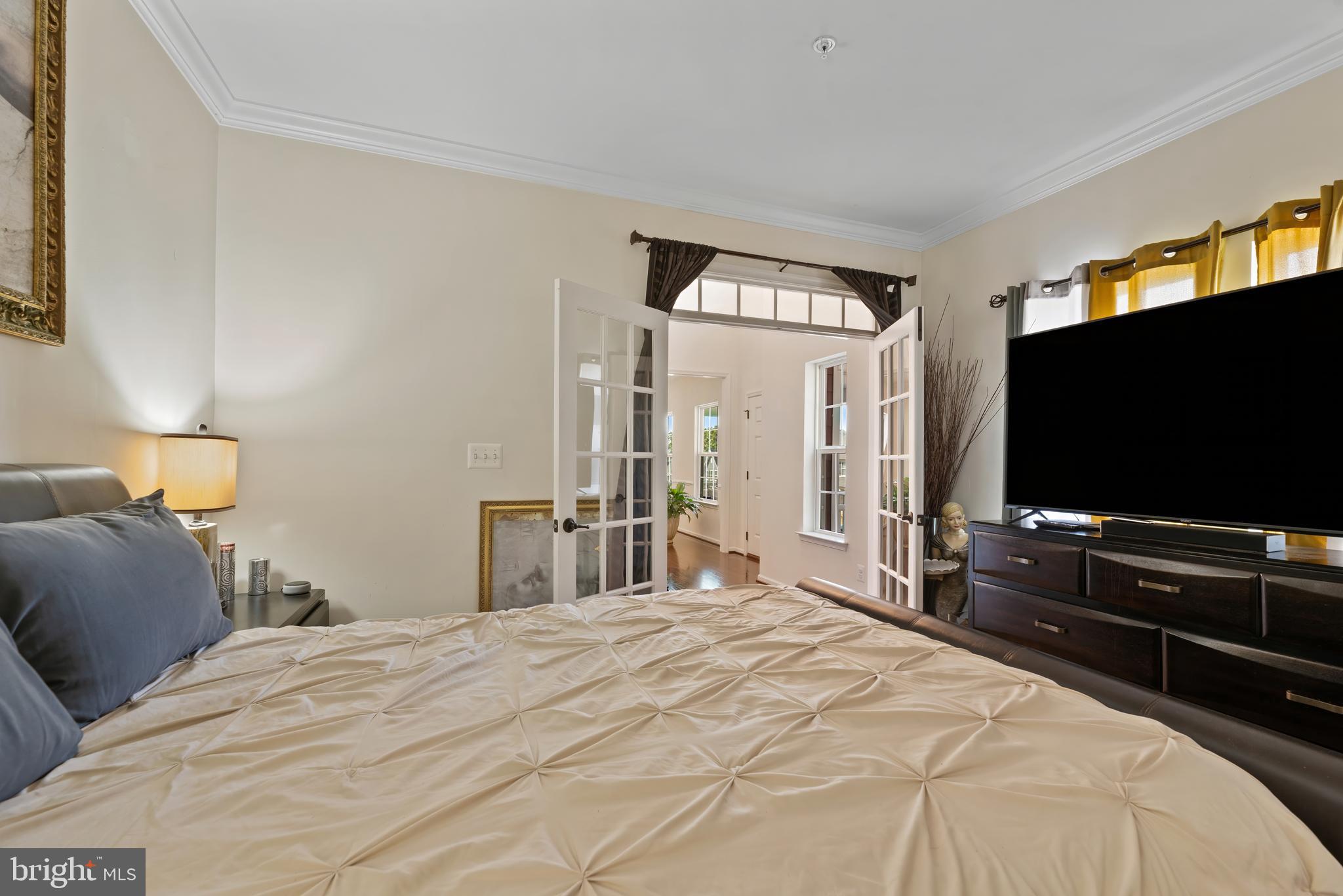 17857 Sugarberry Road Dumfries, VA 22026 - Photo 15 of 53 a bedroom with a bed and a flat screen tv