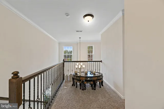 a living room with furniture and a ceiling fan