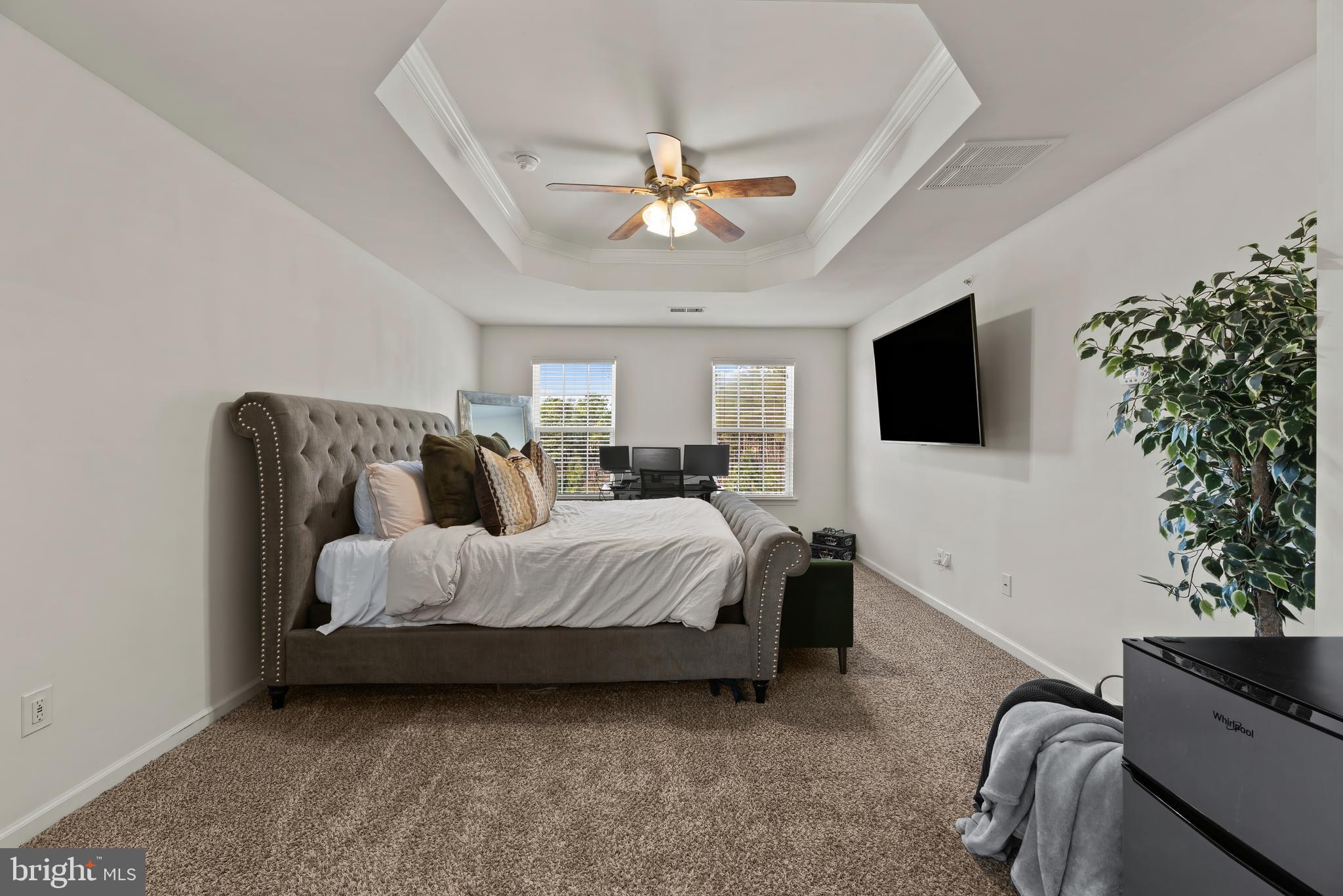 17857 Sugarberry Road Dumfries, VA 22026 - Photo 26 of 53 a spacious bedroom with a bed and a flat screen tv