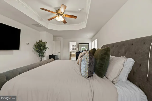 a bathroom with a granite countertop double vanity sink a mirror and a shower