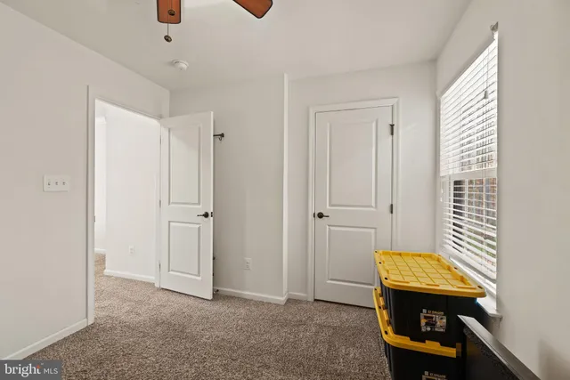 a bathroom with a granite countertop sink toilet mirror and shower