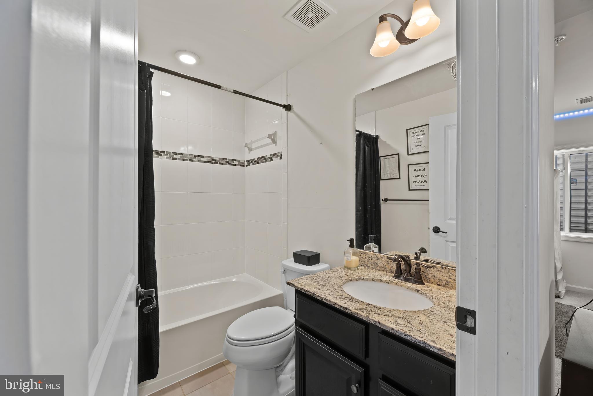 17857 Sugarberry Road Dumfries, VA 22026 - Photo 48 of 53 a bathroom with a granite countertop sink toilet and shower