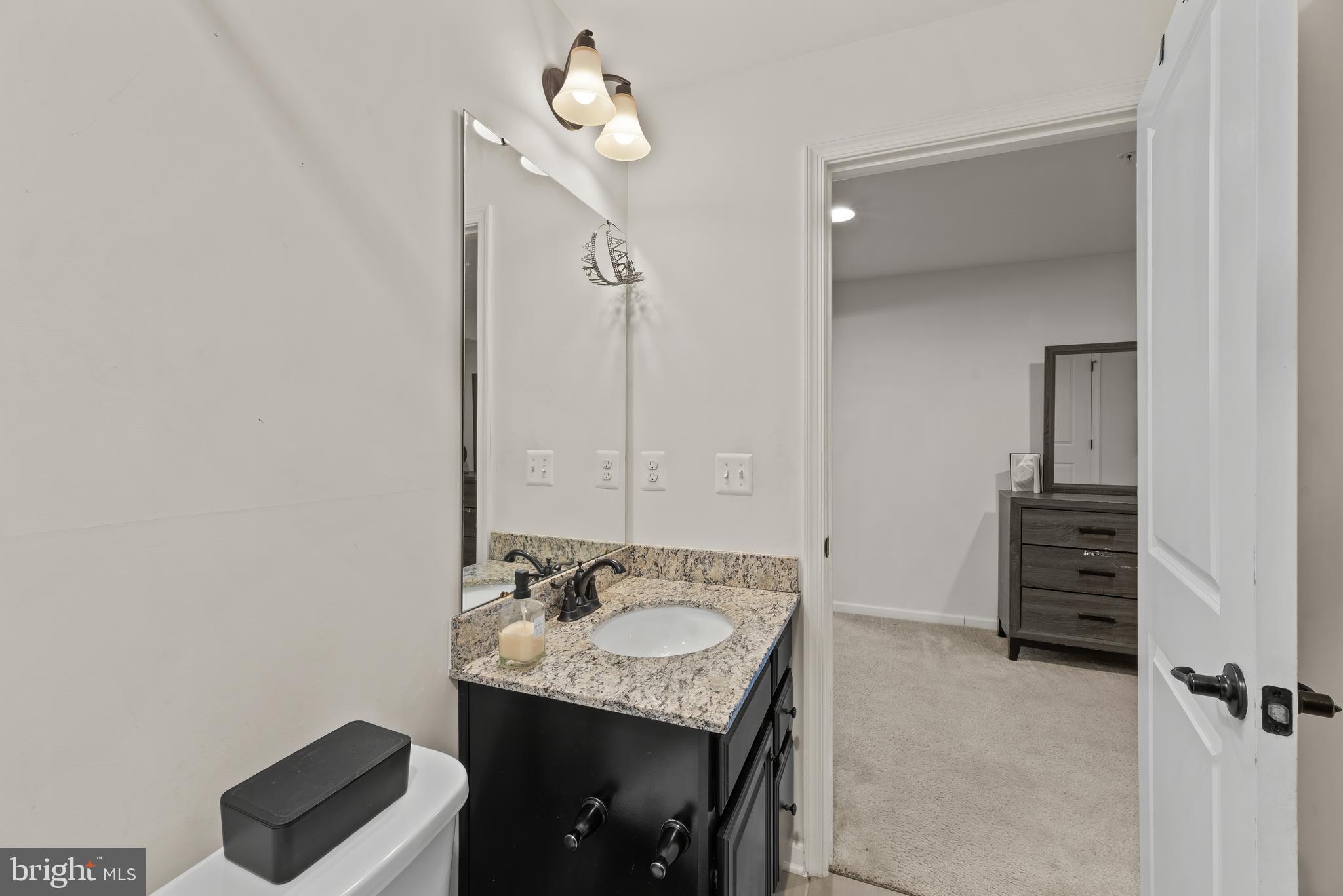 17857 Sugarberry Road Dumfries, VA 22026 - Photo 49 of 53 a bathroom with a sink vanity and mirror