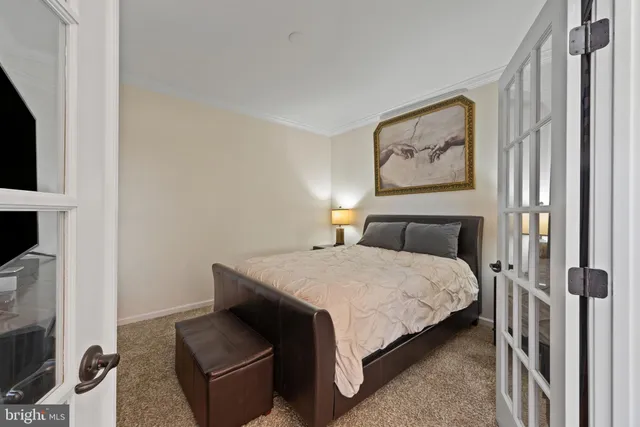 a bedroom with a bed and glass window