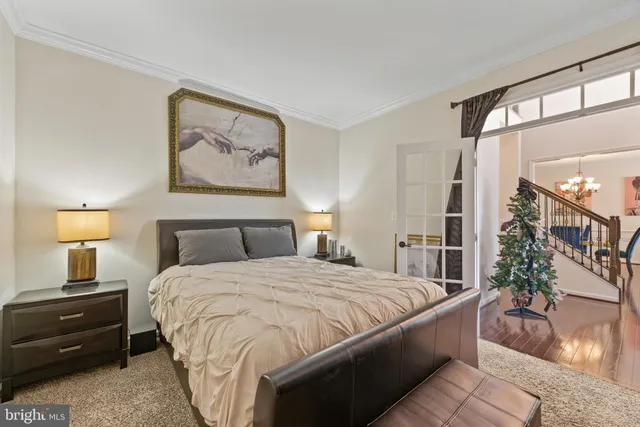 a bedroom with a bed and a painting on the wall