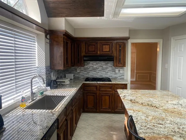 a kitchen with a sink stove and cabinets