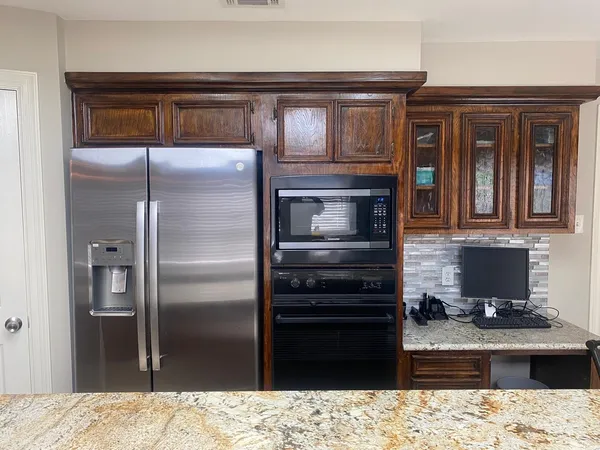 a kitchen with a refrigerator and microwave