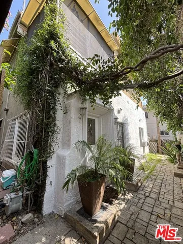 a view of a house with potted plants