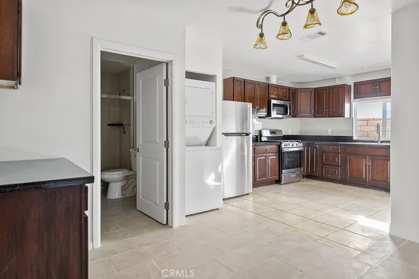 a kitchen with stainless steel appliances granite countertop a refrigerator and a stove top oven
