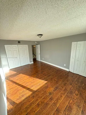 an empty room with wooden floor