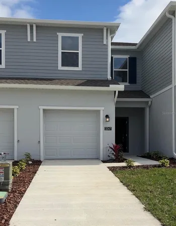 a view of a house with a yard and garage