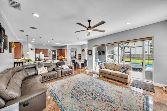 a bedroom with a large bed and a chandelier