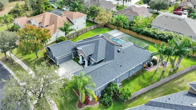 a front view of a house with a yard and potted plants