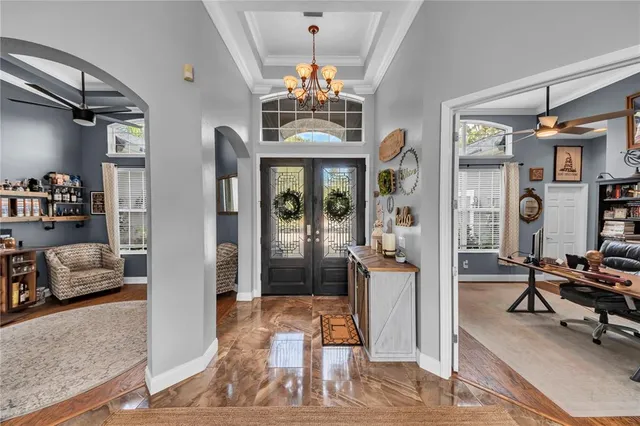 a room with stainless steel appliances furniture a rug and a kitchen view