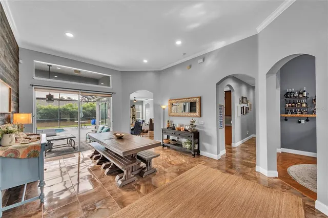 a bedroom with furniture and a large window
