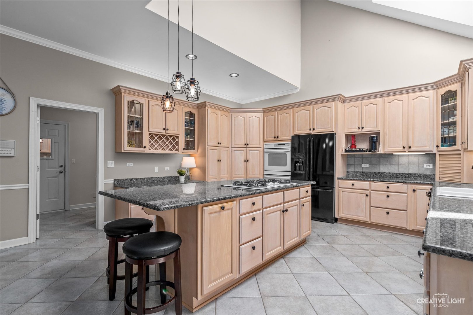 4811 Sebastian Court Naperville, IL 60564 - Photo 13 of 49 a kitchen with stainless steel appliances granite countertop a stove top oven a sink dishwasher and a refrigerator with wooden cabinets