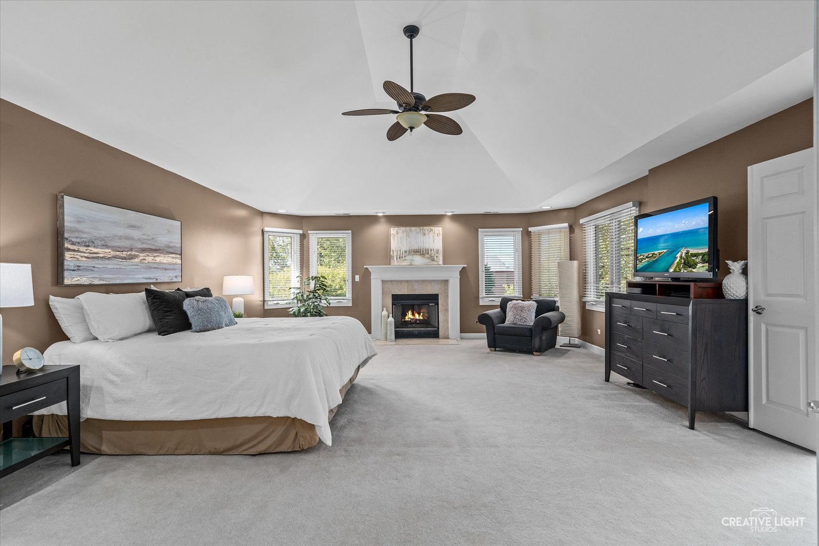 4811 Sebastian Court Naperville, IL 60564 - Photo 19 of 49 a spacious bedroom with a bed and a fireplace