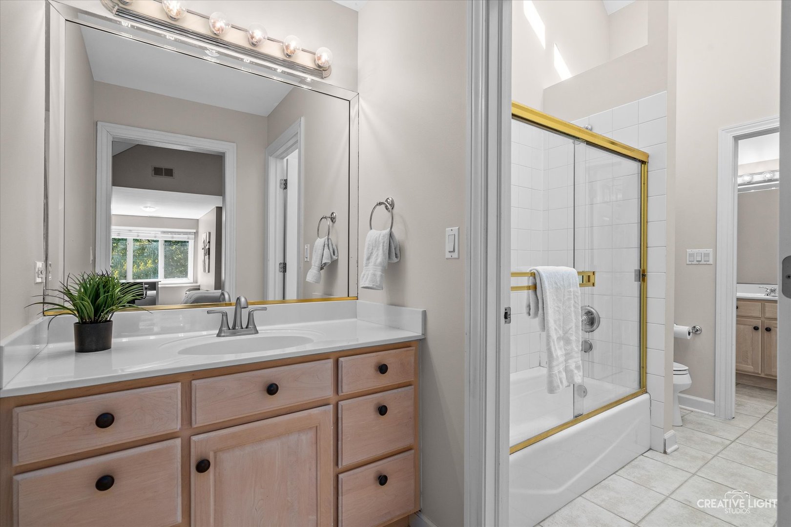 4811 Sebastian Court Naperville, IL 60564 - Photo 23 of 49 a bathroom with a granite countertop sink mirror and shower