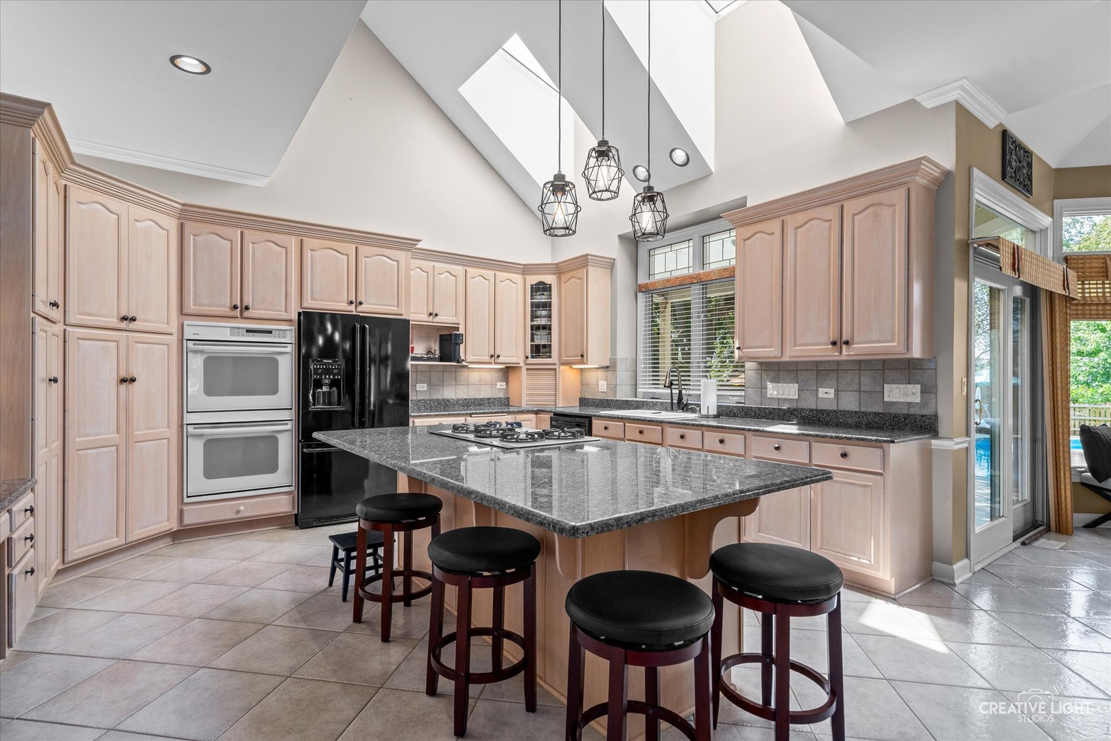 4811 Sebastian Court Naperville, IL 60564 - Photo 10 of 49 a kitchen with stainless steel appliances a dining table and chairs