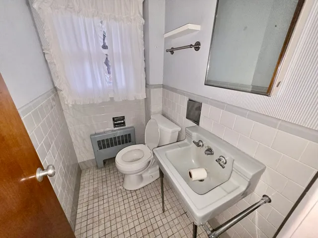 a white toilet sitting next to a bathroom sink