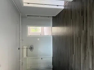 a kitchen with granite countertop white cabinets and black appliances