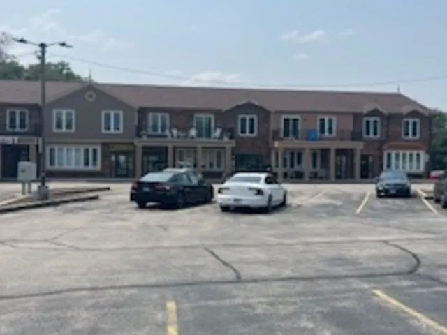 a car parked in front of a brick building