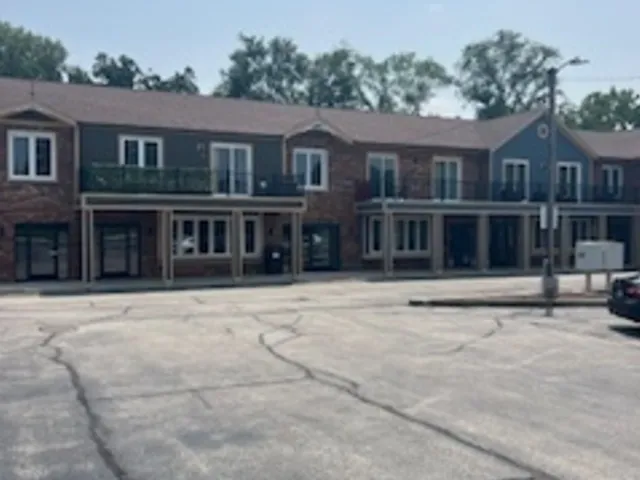 a view of a white house with large windows