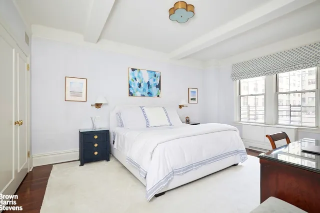 a bathroom with a granite countertop toilet sink and mirror