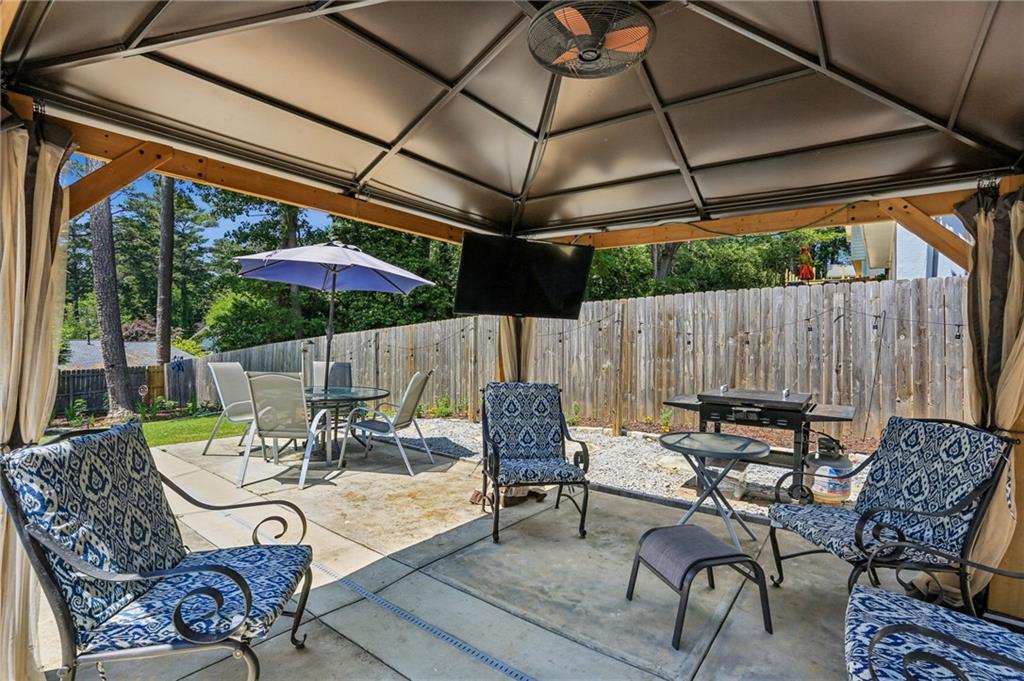 2740 Frontier Trail Atlanta, GA 30341 - Photo 6 of 29 a view of a patio with couches table and chairs under an umbrella