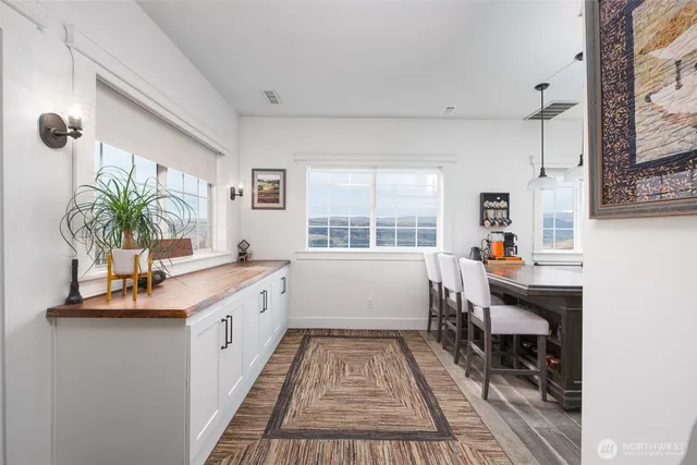 a spacious bathroom with a granite countertop sink a large mirror and a bathtub next to a window