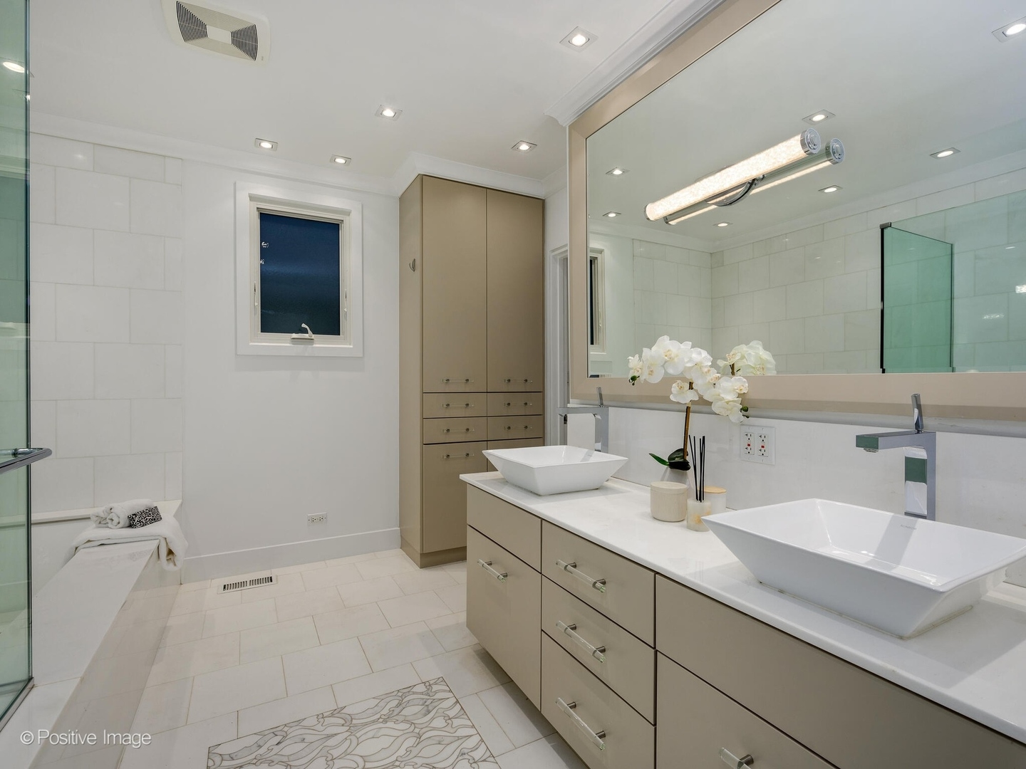 2034 North Burling Street Chicago, IL 60614 - Photo 20 of 32 a bathroom with a double vanity sink a mirror and a shower