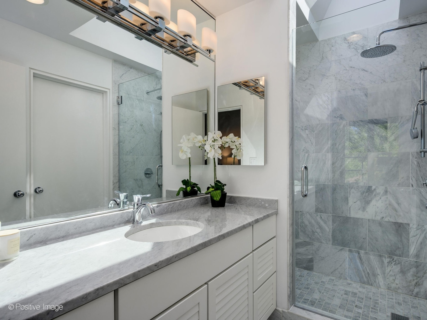 2034 North Burling Street Chicago, IL 60614 - Photo 25 of 32 a bathroom with a granite countertop sink a mirror and a shower