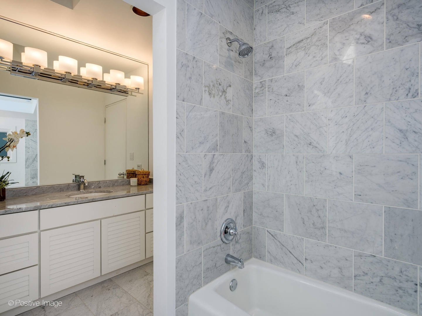 2034 North Burling Street Chicago, IL 60614 - Photo 29 of 32 a bathroom with a granite countertop sink a mirror and a bathtub