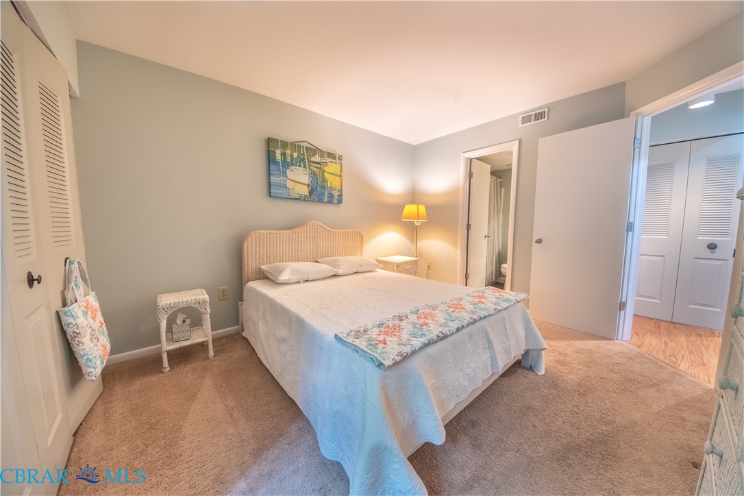 54 Villa Ridge Drive, Unit C Hartfield, VA 23071 - Photo 32 of 45 Bedroom featuring a closet and carpet flooring