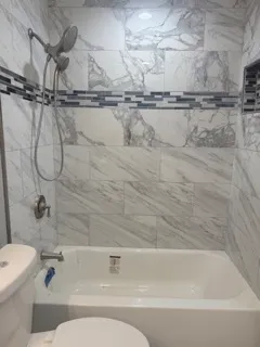 a bathroom with a shower and a toilet