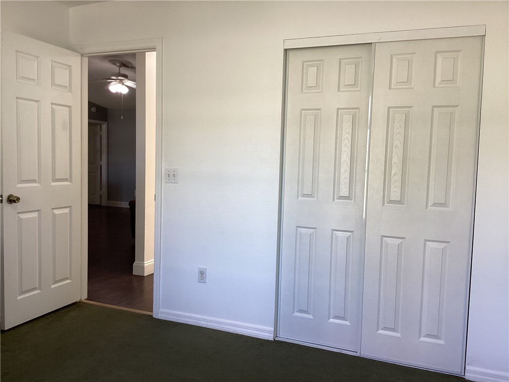 8001 Roberts Road Fort Pierce, FL 34951 - Photo 17 of 29 an empty room with wooden floor and closet area
