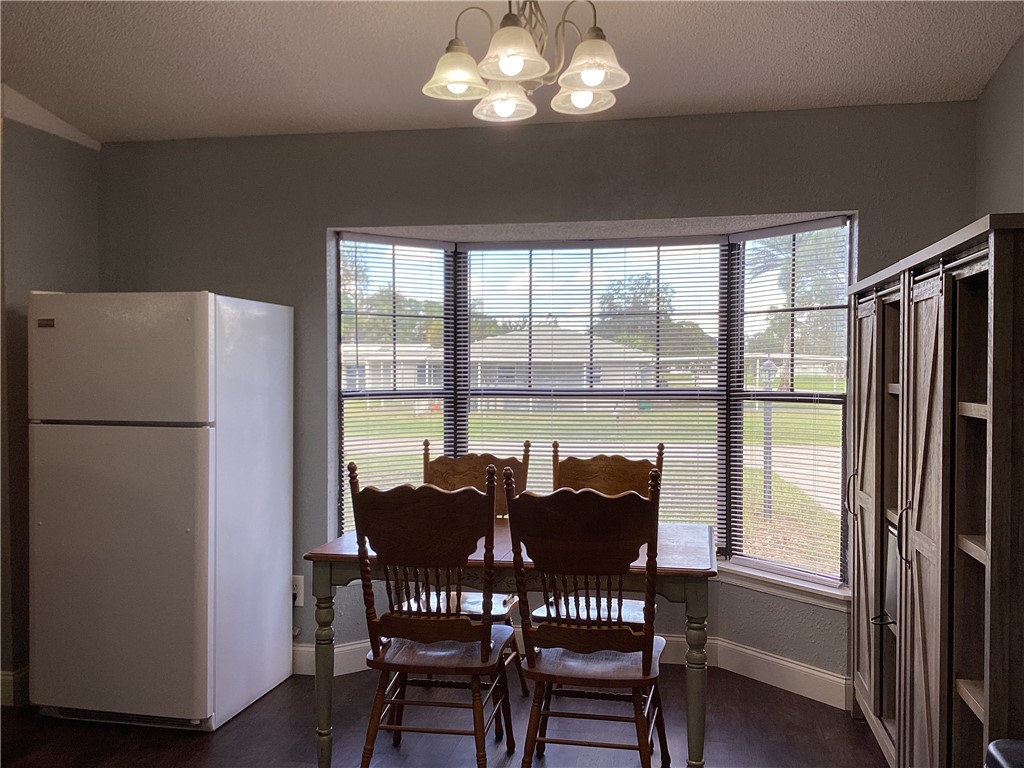 8001 Roberts Road Fort Pierce, FL 34951 - Photo 9 of 29 a view of a dining room with furniture large window and refrigerator